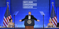 Donald Trump speaking at a lectern bearing the presidential seal.