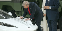 President Donald Trump signs a Corvette as he tours General Motors' Milford Proving Ground in Milford, Mich., on July 27, 2026.