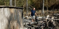 A man searches through the rubble
