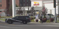 A law enforcement officer stands outside an In-N-Out Burger restaurant in Twin Falls, Idaho, where a shooting was reported Saturday.