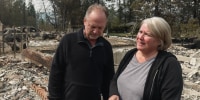Ken, left, and Lisa Anderson stand among debris from a damaged house outside