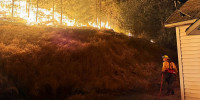 A firefighter battles the Fairview Fire in Spokane County, Wash.