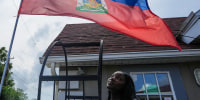 Patricia Grace Louis-Jacques with the Haitian flag.