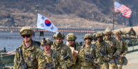 U.S. Army soldiers cross a pontoon bridge on the Imjin River