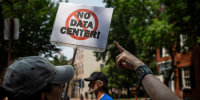 Demonstrators in the street hold a sign that says; "No Data Center!"