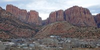 Hildale, Utah, sitting at the base of Red Rock Cliff mountains, with its sister city, Colorado City, Ariz., in the foreground in 2014. 