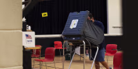 A person casts their ballot at an early voting polling location in Houston