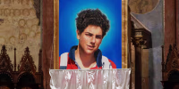 An image of 15-year-old Carlo AcutiS is unveiled during his beatification ceremony at St. Francis Basilica in 2020.