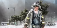 A New York City firefighter walks away from Ground Zero