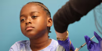 A child receives a COVID-19 vaccination in Culver City, Calif., on Sept. 23, 2025.