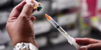 A medical assistant prepares a dose of the measles, mumps and rubella (MMR) vaccine.