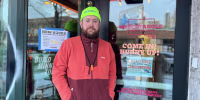 Jeff Rogers stands in front of the doorway to Wrecktangle Pizza