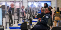 A TSA agent at a screening checkpoint.