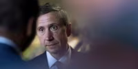 Ken Martin is partially obscured by a heavily-blurred foreground.