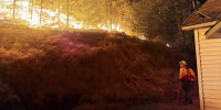 A firefighter battles the Fairview Fire in Spokane County, Wash.