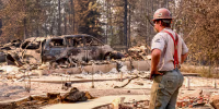 A worker pauses to look at the debris.