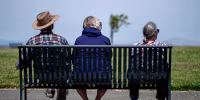 People sit on a bench in Hercules, California, US, on Thursday, June 20, 2024. 