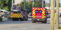 A fire truck and emergency vehicle are seen on the street