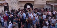 Mourners carry the coffin of Mohammad Ghamira