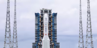 A rocket and booster are displayed upright