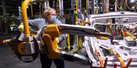 A workers welds vehicle doors at the General Motors assembly plant in Oshawa, Ontario, in 2021. 