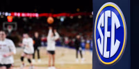 The SEC logo is seen while people play on the court.