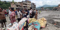 Residents stand next to piles of belongings in Trushuli, Nepal on Aug. 29, four days after devastating floods swept through the region, killing hundreds.