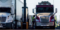 Drivers refuel trucks with diesel fuel at a Pilot gas station