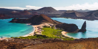 View on the volcanic landscape of Bartolome Island with famous Pinnacle Rock and Golden Beach, Galapagos Islands, Ecuador