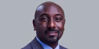 Image: A headshot of Prince Edward Kijanangoma Rukidi, wearing a suit.