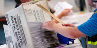 Mail-in ballots in a USPS box.