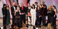 Katie Dippold and cast/crew accept an Emmy Award.