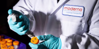 A researcher works in the lab at the Moderna headquarters in Cambridge, Mass.