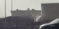 This frame grab taken from AFPTV video footage on September 19, 2026 shows a tank leaking at the scene of a fire at the Aramco fuel depot near King Khalid International Airport in Riyadh. Black smoke and flames rose near Riyadh's international airport on September 19, as a flight tracking website reported cancellations and delays at the hub, hours after Saudi authorities issued an air raid alert. (Photo by AFPTV / AFP via Getty Images) / 