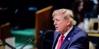 Donald Trump speaks at a podium