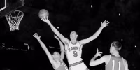 A black and white photo of on-court action during an NBA game.