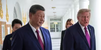President Trump and President Xi Jinping walking along the White House colonade with their wives behind them.