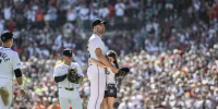 Justin Verlander hugs his daughter on the pitching mound in front of a stadium full of fans.