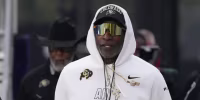 Sep 19, 2026; Evanston, Illinois, USA; Colorado Buffaloes head coach Deion Sanders takes the field with his team for warmups before the game against the Northwestern Wildcats at Northwestern Medicine Field at Martin Stadium. Mandatory Credit: David Banks-Imagn Images
