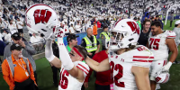 Sep 26, 2026; University Park, Pennsylvania, USA; Wisconsin Badgers safety Grant Dean (16) and wide receiver Dorsett Stecker (22) react while exiting the field following the game against the Penn State Nittany Lions at West Shore Home Field at Beaver Stadium. Mandatory Credit: Matthew O'Haren-Imagn Images