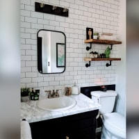 This bathroom's wall of white subway tile only cost $3