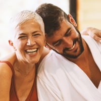 Mature woman and younger man are having fun at the spa.