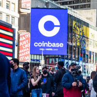 Monitors display Coinbase signage during the company's initial public offering at the Nasdaq MarketSite in New York on April 14, 2021.