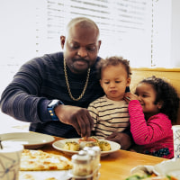 Father dining with children at pizzeria