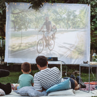 family watching a movie on a projector 