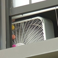 Shot of a fan in a classroom from the window.