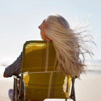 Womans hair blowing in wind on beach
