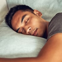 Shot of a young man sleeping in bed.