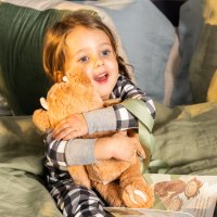 little girl hugging a teddy bear