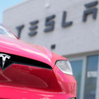 Tesla 2023 Model X sports-utility vehicle outside a Tesla dealership.